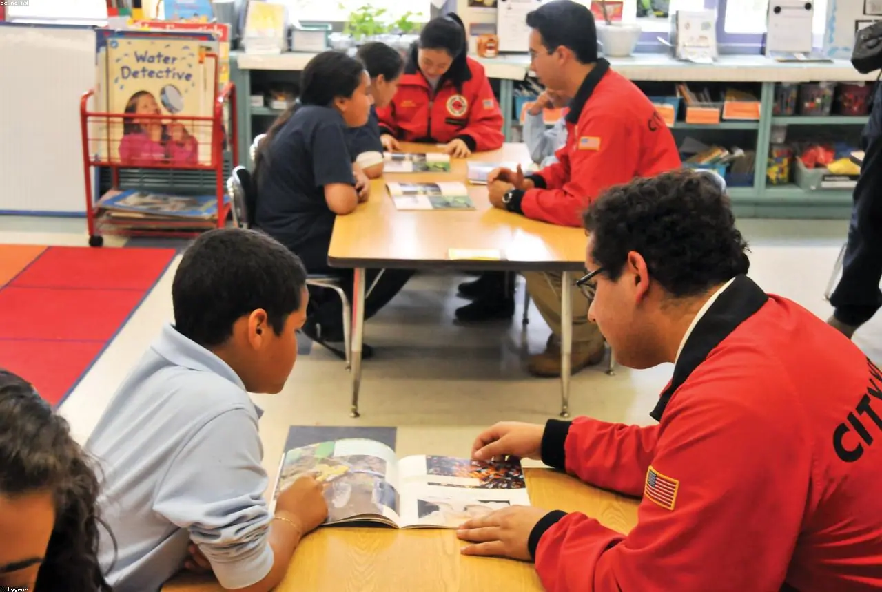 A mentor helping a student with schoolwork